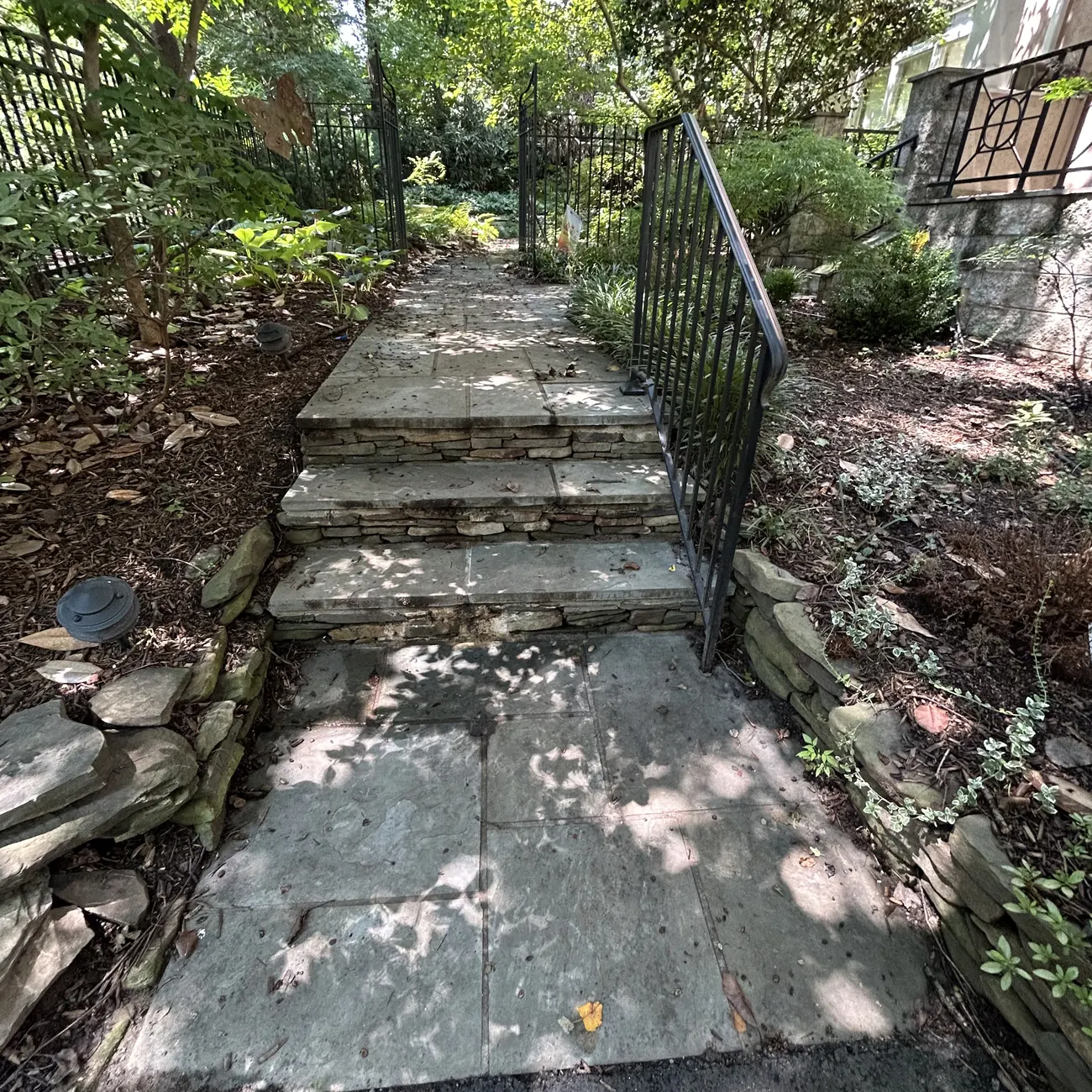 Before: Stone steps and beds, leaves cleared and fresh mulch laid